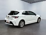 a white toyota corollant parked in a large room