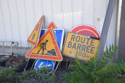 many road signs that are sitting in the grass