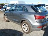the rear of a silver car is parked in a parking lot