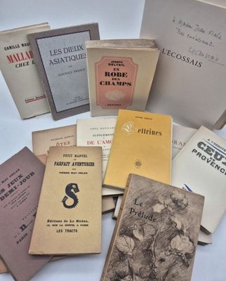 several books are stacked on top of each other on a table