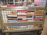 a large metal cart with many boxes of cigarettes on it