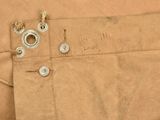 a brown piece of cloth with buttons on it