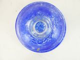 a blue glass bowl on a white table