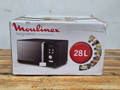 the box of a microwave is sitting on a wooden table
