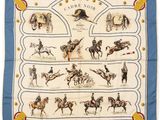 a blue and white scarf with a picture of horses and riders on it