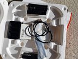 a white box with a cell phone and a charger in it