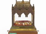 an image of a wooden and glass shrine with a cross on top