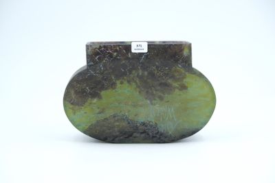 a picture of a green and black vase on a white surface