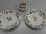two plates and a cup sitting on a table