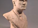 marble bust of a man in a suit and tie on a gray background