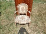 une chaise posée dans l'herbe à côté d'une commode