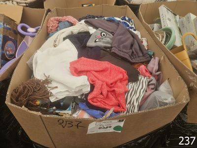 a cardboard box filled with clothes and other items