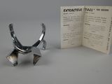 a small metal object that is sitting next to an open book