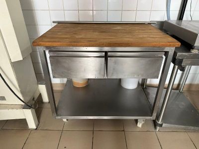 a small table with two cups on it in a kitchen