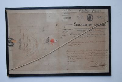 an old document on the wall with a stick sticking out of it
