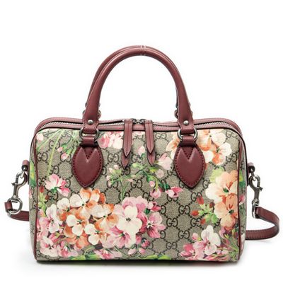 a brown and pink floral bag on a white background