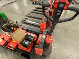 a picture of a forklift in a warehouse with a man in the background
