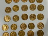 a lot of gold coins that are on the table