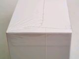 a white box sitting on top of a table covered in plastic