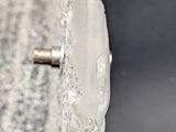 a close up of a metal object on a black surface