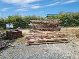 a pile of wood sitting on the side of the road