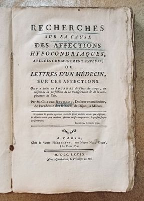 an old book that is open on a table