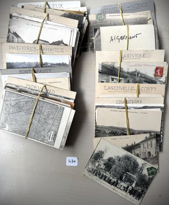 a lot of old postcards that are tied to a table