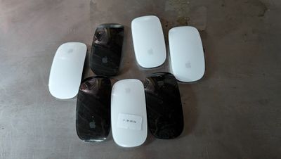 four white apple mouses sitting on top of a table next to each other