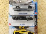 three hot wheels cars in the package on the table