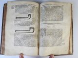 someone is holding an open book with some writing on it