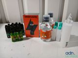 a bottle of water, a bottle of liquid, a bottle of mouthwash, a bottle of mouthwash and a bottle of mouthwash on a table
