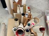 many rolls of toilet paper on the floor next to a box