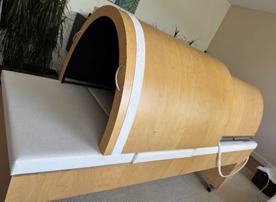 a bed with a wooden frame and a white mattress