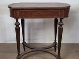 an old wooden table with a drawer on top of it