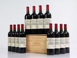 six bottles of red wine in a wooden box on a white surface