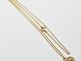 a gold necklace with a heart and a star on it