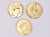 three gold coins with a picture of a man and a woman on them