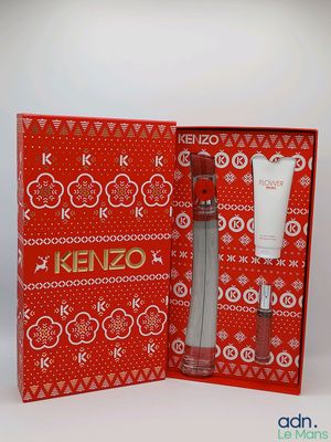 a close up of a red box with a bottle of kenzo on it