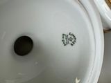 a close up view of a white and gold vase