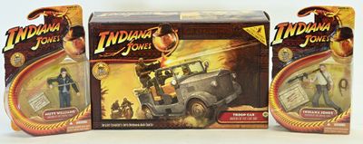 three indiana jones action figures are shown in a display case