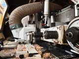 a machine that is working on a piece of wood