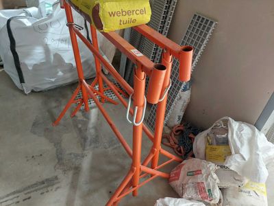 a pile of bags sitting on the floor next to a construction crane