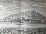 an old book with a picture of a mountain in the background