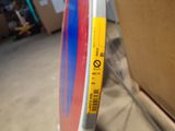 a red, white, and blue skateboard with a yellow sticker on it