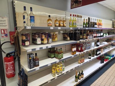 many bottles of alcohol on the shelves in the store