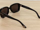 a pair of black sunglasses sitting on top of a wooden table