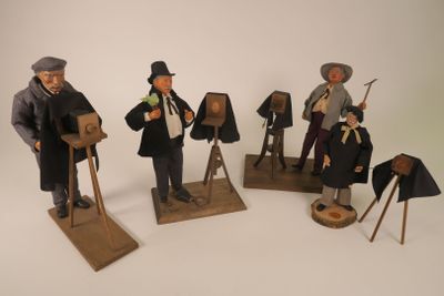 five figurines of men dressed in historical clothing