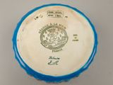 a close up of a blue and white bowl on a table