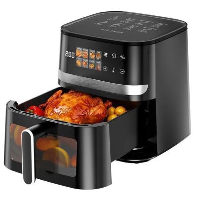 a black air fryer with a turkey inside of it