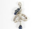 an image of a diamond and sapphire pendant on a white background